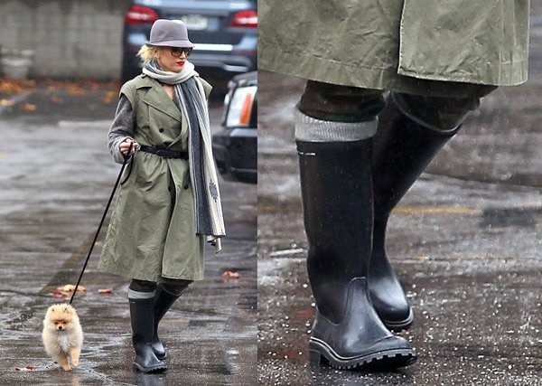 Gwen Stefani takes her dog for a walk on a rainy day, wearing a stylish outfit complete with classic Wellington boots