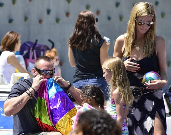 Heidi Klum enjoys a sunny day at the park with her children and boyfriend, radiating joy and casual elegance