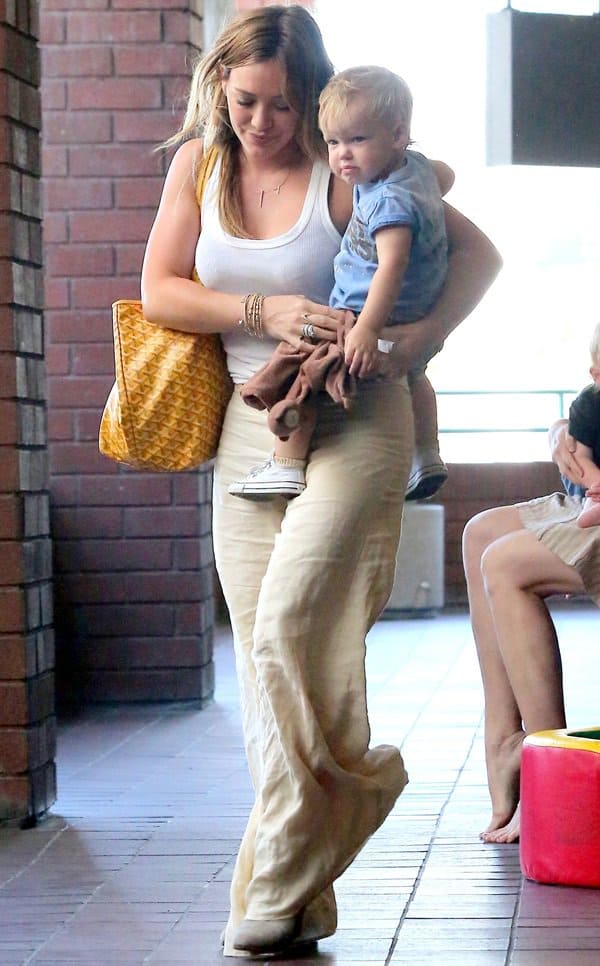 Hilary Duff sported a very summer-perfect ensemble consisting of a plain white tank top and a pair of breezy linen pants