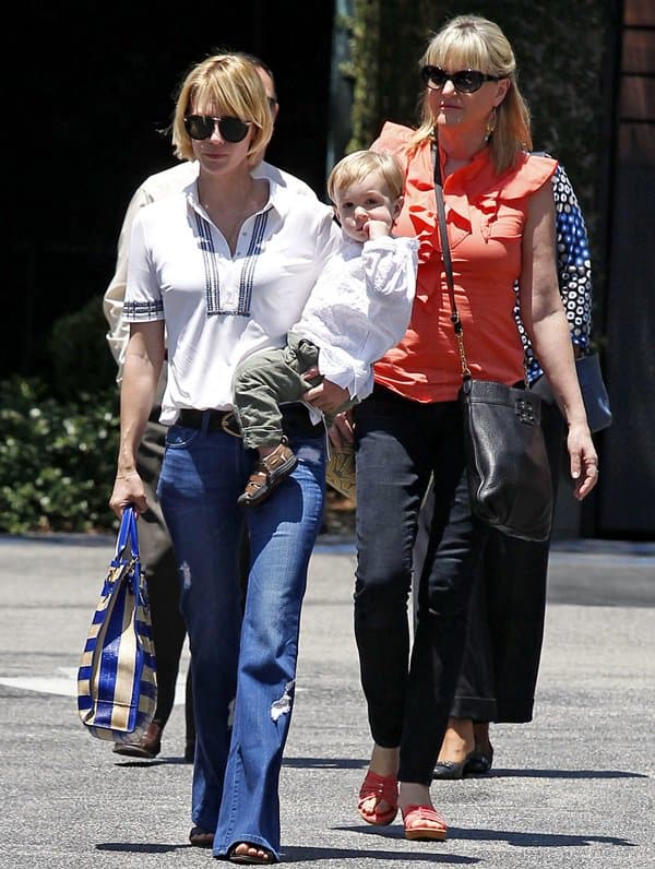 January Jones wearing flared jeans to lunch at Houston’s with son Xander and mother Karen