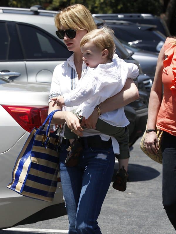 January Jones wearing bohemian style flared jeans with a white button-down blouse