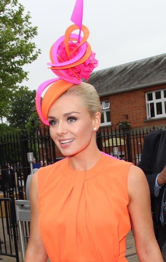 Katherine Jenkins sporting a sculptural fascinator in orange and fuchsia