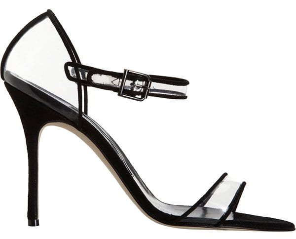 Slick patent frames the cool translucence of a modern-classic pump perched atop a slim, wrapped heel