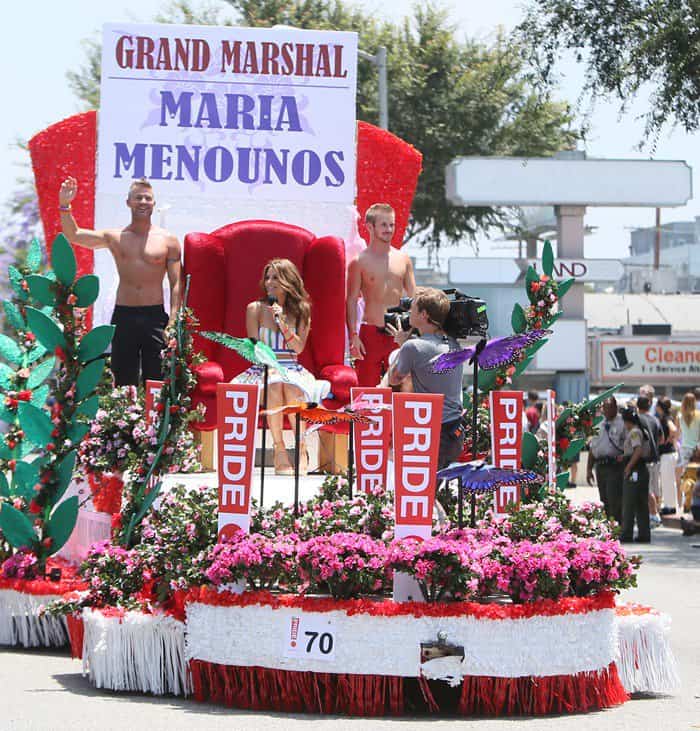 Maria Menounos, the 2013 grand marshal, at the LA Gay Pride Festival in West Hollywood, showcasing her vibrant rainbow-striped outfit