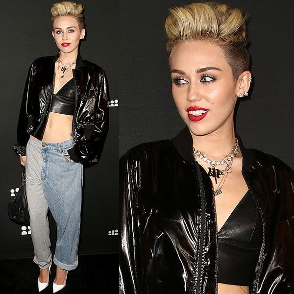 Miley Cyrus turned heads at the Myspace Launch Party on June 12, 2013, in an edgy ensemble featuring Ashish Spring 2013 combination jeans, a KTZ Poet embroidered short bomber jacket in black, a T by Alexander Wang leather triangle bralette, and Christian Louboutin white leather patent Pigalle pumps