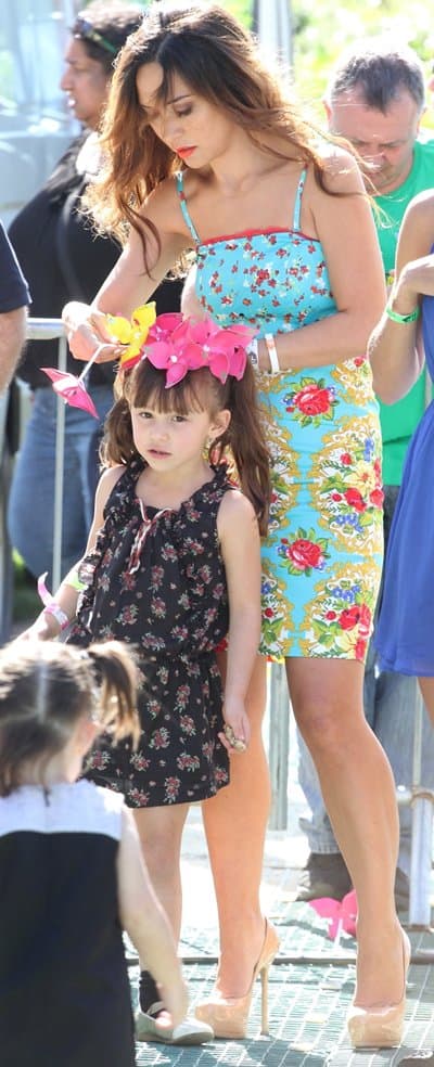 Back in action: Myleene Klass resumes her duties at the Big IF after mending a strap on her charming floral dress