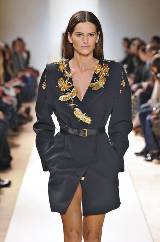 Snapshot from Paris Fashion Week, Autumn/Winter 2013: Rita Ora's chosen Emanuel Ungaro dress coat showcases refined elegance on the runway
