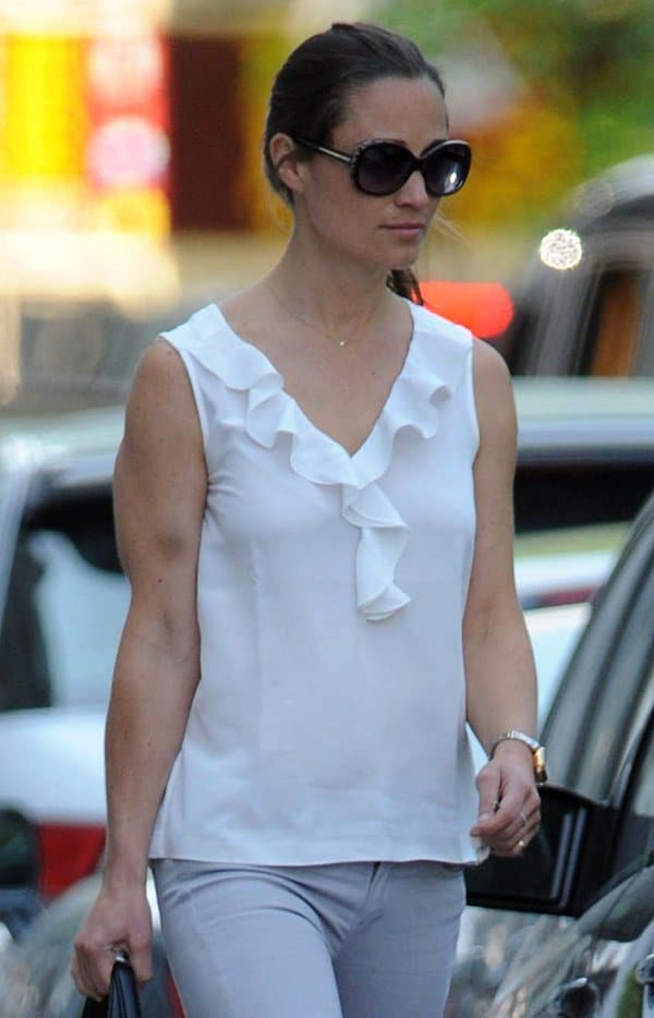 Pippa Middleton exudes sophistication in a white ruffle blouse and grey skinny jeans, accented with oversized sunglasses on June 6, 2013
