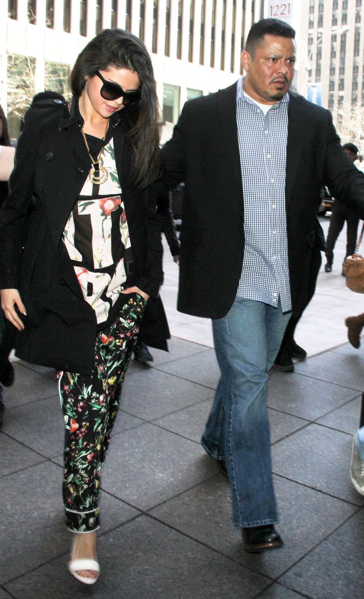 Selena Gomez embraced a relaxed, pajama-inspired ensemble featuring a 3.1 Phillip Lim silk chiffon floral tank and matching trousers, complemented by Bionda Castana 'Elisabetta' sandals while promoting her new single in New York City on April 24, 2013