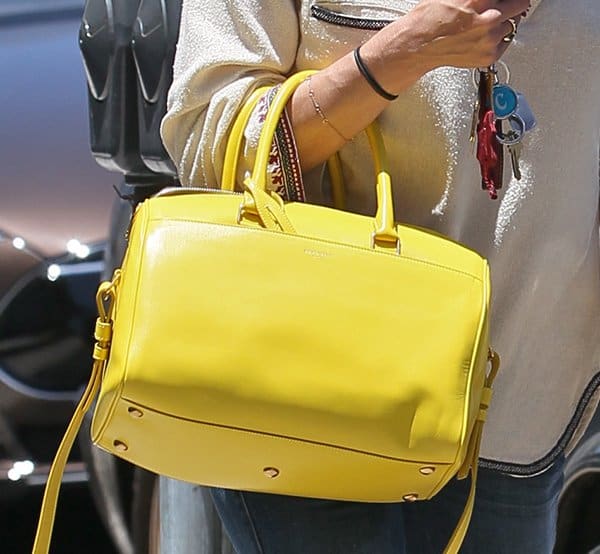 Selma Blair adds a pop of color to her look with a yellow Saint Laurent purse