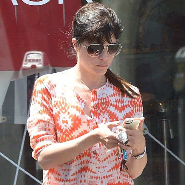 Selma Blair keeps it casual and vibrant in a tie-dye-inspired orange maxi shirtdress while out on Melrose Avenue