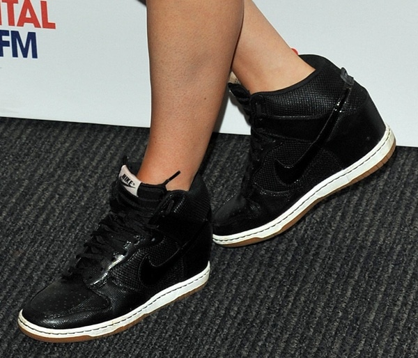 Ellie Goulding's Nike Dunk shoes feature a black leather upper, white and yellow rubber sole and a 55mm high heel wedge for added height
