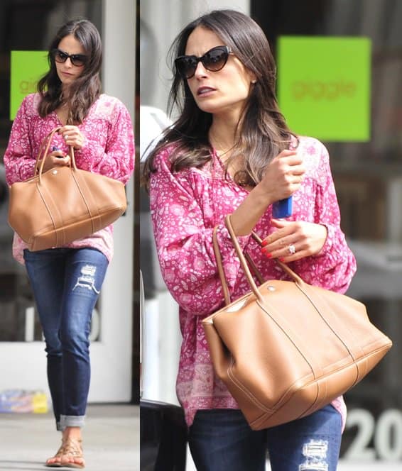 Jordana Brewster, captured in a boho-chic look with a printed pink tunic, ripped jeans, and Tory Burch sandals, completes her ensemble with sunnies and a tan tote in Brentwood, LA, on June 5, 2013