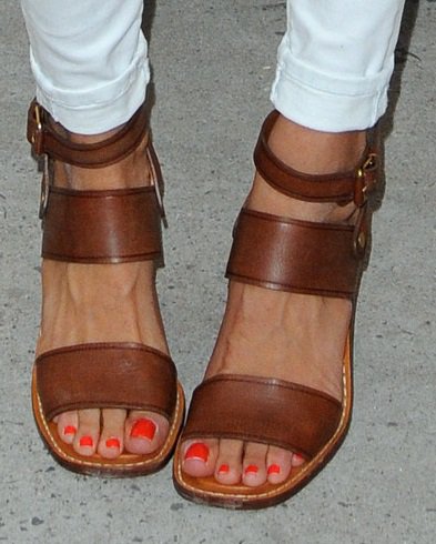 Rebecca Minkoff shows off her feet in banded brown sandals