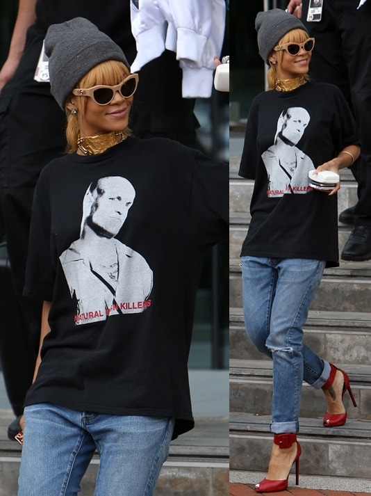 Rihanna wearing loose jeans, a graphic tee, a beanie, and cat-eye sunnies while leaving her hotel in Manchester on June 13, 2013