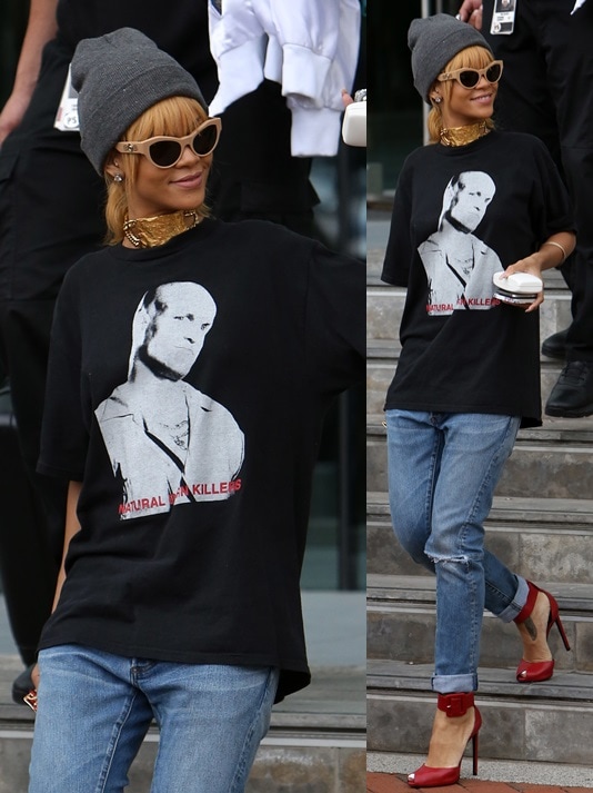 Rihanna wearing loose jeans, a graphic tee, a beanie, and cat-eye sunnies while leaving her hotel in Manchester on June 13, 2013