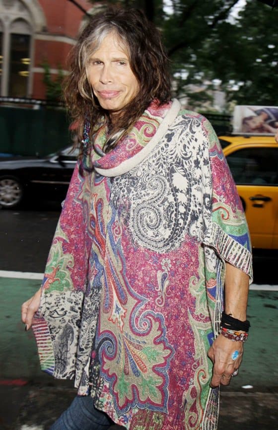 Steven Tyler heads to the Stella McCartney Spring 2014 Presentation in New York while decked in a printed poncho on June 10, 2013 