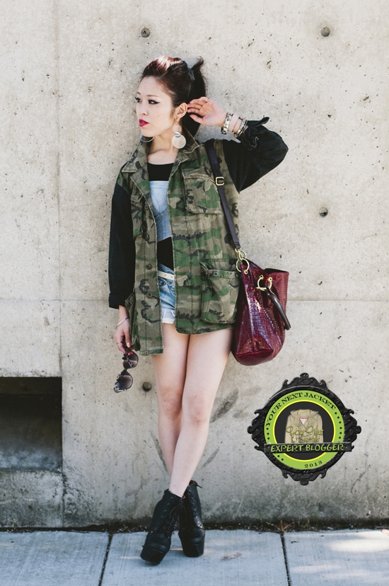Aika brings a fresh and chic twist to the military trend, artfully matching her green camo jacket with classic denim shorts for a casual yet trendy look