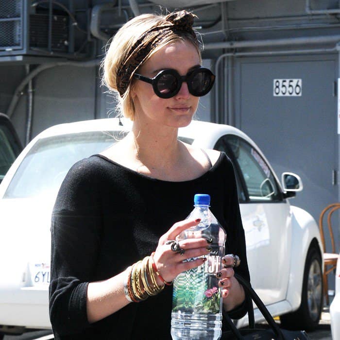 A pile of bangles making Ashlee Simpson's all-black attire shimmer as she leaves the dance studio