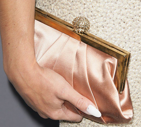 Cara Santana toted a gorgeous satin clutch