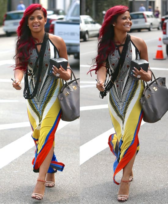 Christina Milian, showcasing vibrant red hair, strolls in Beverly Hills wearing a colorful maxi dress, July 3, 2013