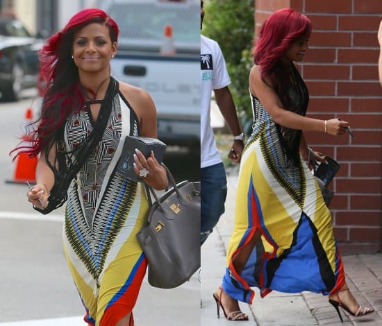 Christina Milian radiates joy with her magenta hair complementing her vividly patterned maxi dress