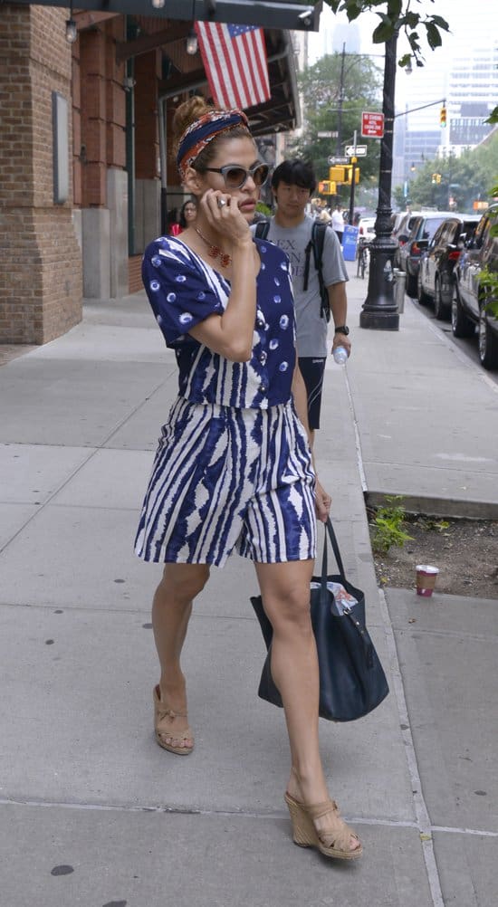 Eva Mendes adds a splash of patriotic flair with a red-and-blue headscarf, complementing her retro look during a Manhattan outing