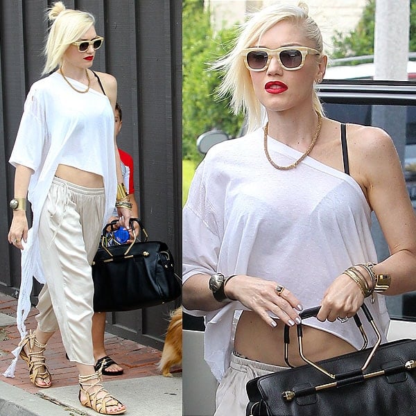 Gwen Stefani rockin' her version of a white t-shirt, khakis, and sandals, putting her unique personal touch to it via striped wayfarers, a to-die-for Viktor & Rolf "Bombette" handbag, and her signature red lips