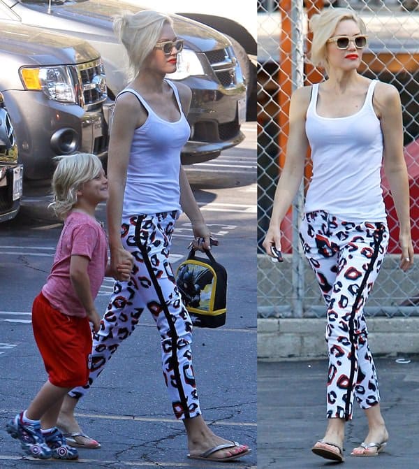 Gwen Stefani turned heads in Beverly Hills on July 24, 2013, wearing bold L.A.M.B. Spring 2013 leopard-print pants, Triwa Henry sunglasses, and a chic white tank top, effortlessly blending edgy style with casual elegance