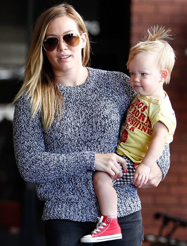 Hilary Duff walks hand-in-hand with her son, Luca, to a Mommy and Me class in Sherman Oaks, showcasing her resilient spirit and casual chic style, June 26, 2013