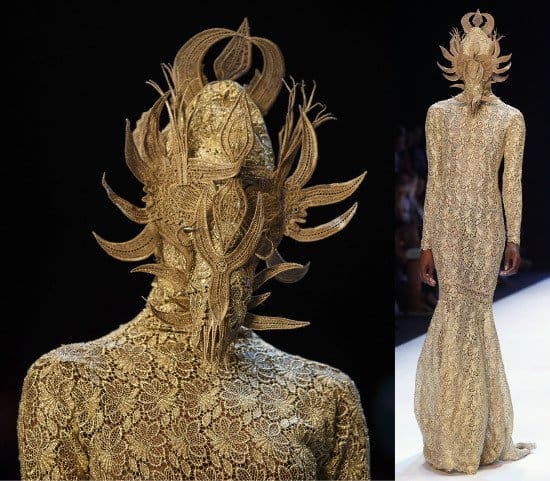 The ensemble of the show — an exquisitely detailed figure-hugging dress paired with a mask with woven extensions
