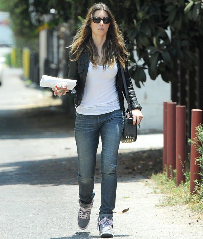 Jessica Biel was styled in a casual yet trendy ensemble featuring Tom Ford Snowdon sunglasses, an Alexander Wang Lia bag in black, white, and purple Air Jordan Spizike sneakers, an AllSaints Belmont leather jacket, and a Rag & Bone tank top