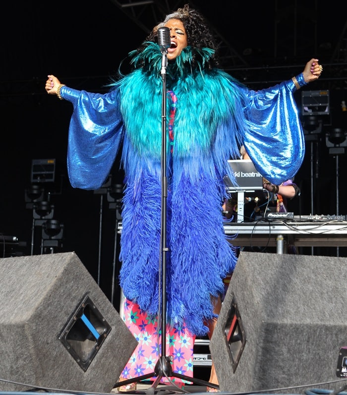 Kelis dazzles on stage during Day 3 of the Lovebox Festival at Victoria Park, London, in 2013, donning a striking blue feather ensemble