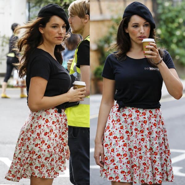 Captured on a brisk July day, Kelly Brook enjoys a warm beverage while filming 'Taking Stock' in London, showcasing her versatile style by wearing dresses as skirts