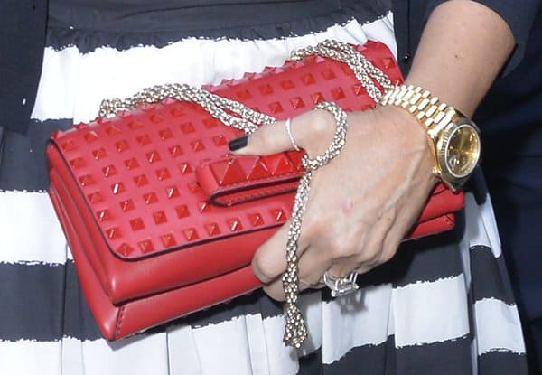 Close-up of the exquisite Valentino Rock Stud Chain Flap Bag featuring pyramid studs and a chic woven gold chain strap