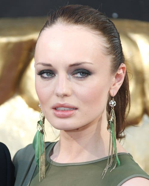 Laura Haddock at the 2012 Arqiva British Academy Television Awards in London, showcasing a laid-back yet chic feather earring style, May 27, 2012