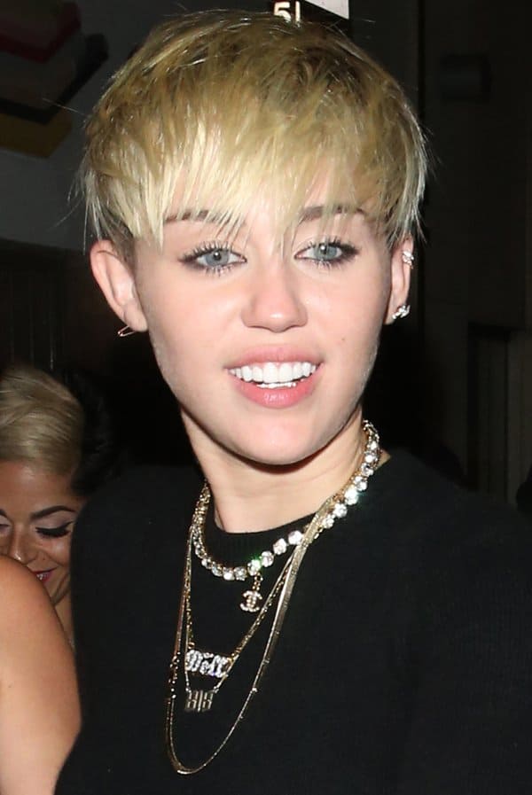 Miley Cyrus shines with statement jewelry, embracing London's vibrant club scene with her bold, golden accessories