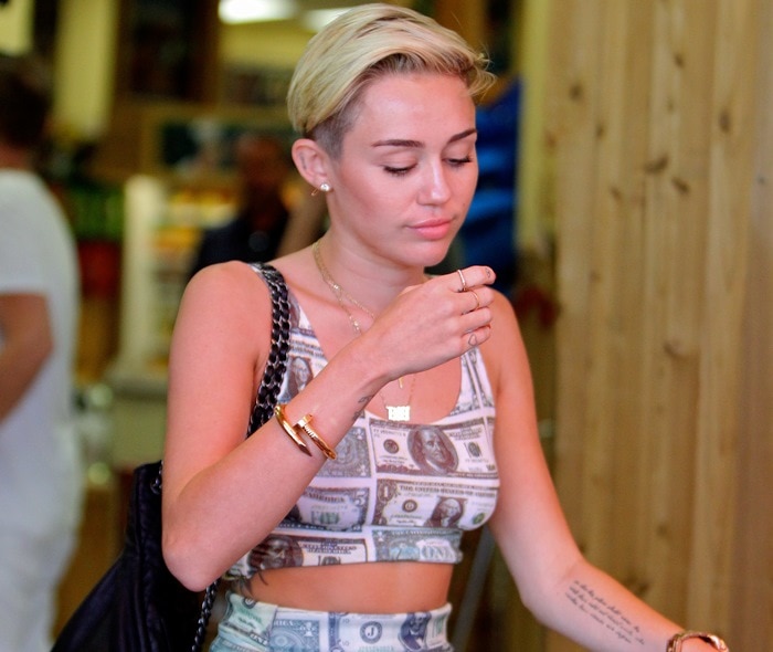 Miley Cyrus showing a lot of skin as she runs errands with her mom at Trader Joe's in Toluca Lake, California on July 12, 2013