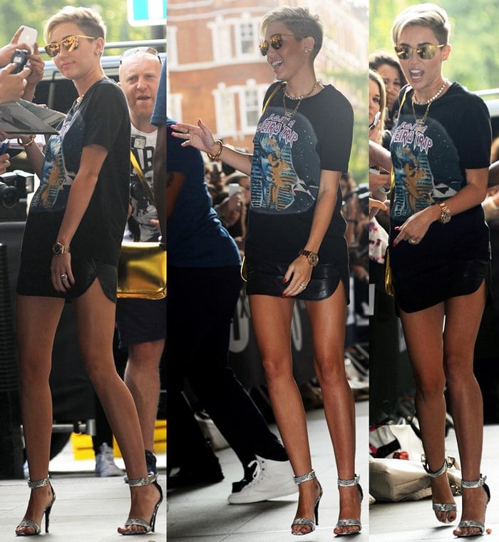 Miley Cyrus in a graphic tee paired with an itty-bitty leather miniskirt