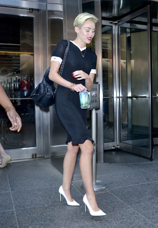 Miley Cyrus departs Good Morning America in a sheer black dress, blending sophisticated style with daring transparency