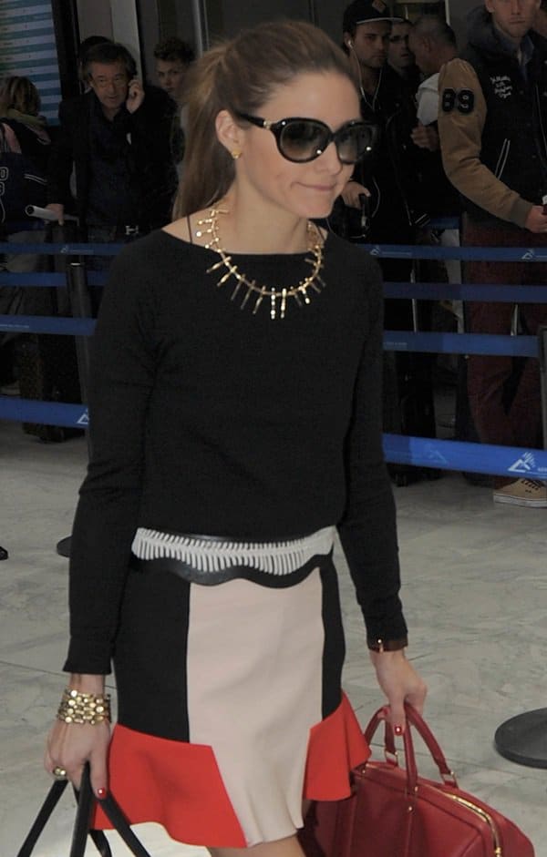 Olivia Palermo makes a stylish entrance at Nice Airport for the 66th Cannes Film Festival, showcasing a chic color block skirt and sophisticated accessories on May 25, 2013