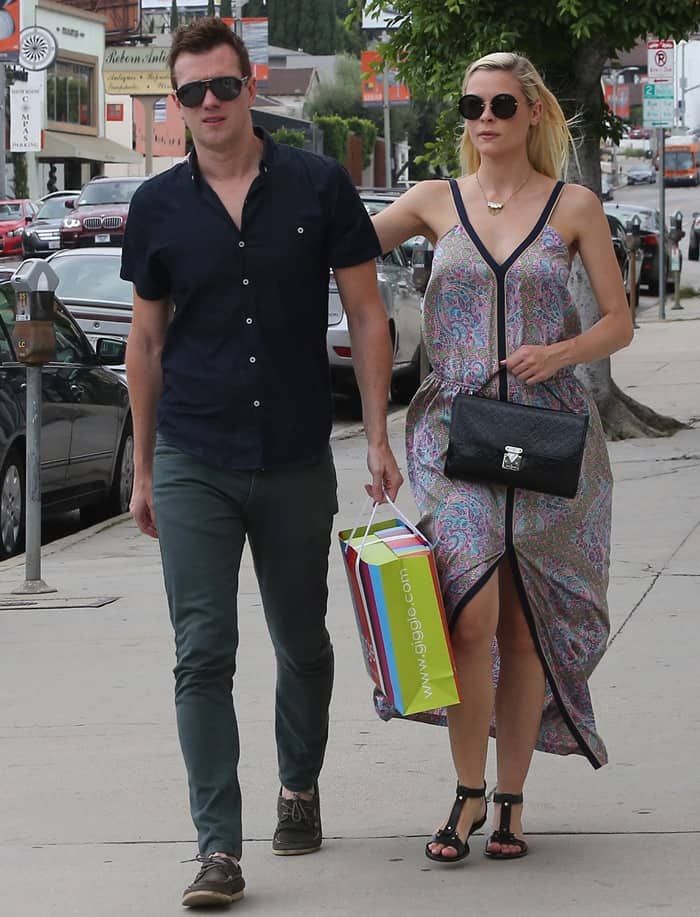 Jaime King, wearing a printed maxi dress with black T-strap flat sandals, steps out with husband Kyle Newman, who keeps it casual in a navy shirt and green chinos, during a shopping trip in West Hollywood on June 30, 2013