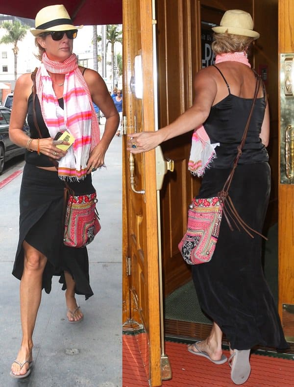 Rachel Hunter elevates a simple black outfit with a colorful scarf and an embroidered bohemian bag