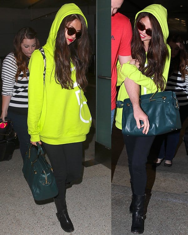 On July 10, 2013, at LAX Airport, Selena Gomez was seen wearing Vince Camuto Walt Stud boots, a Viktor & Rolf Bombette bag, Adidas Neo Selena Gomez leggings, an Adidas Neo logo hooded sweatshirt in intense lime/running white, and Elizabeth and James Taylor cat eye sunglasses
