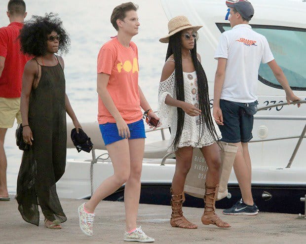 Making sure not to waste any time to soak up the sun, Solange came already dressed for the occasion and location in a cutout-shoulder crochet dress, a straw hat, cat-eye sunglasses, and trendy tall gladiator sandals