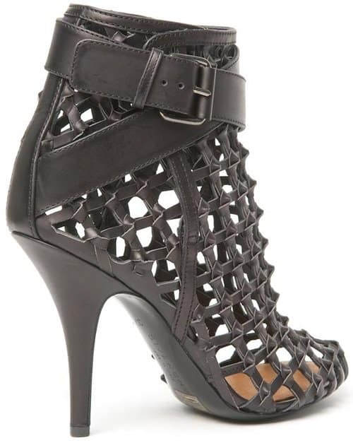 Close-up of Gwen Stefani's chic Givenchy cage booties, featuring intricate woven details and wrap-around buckled straps
