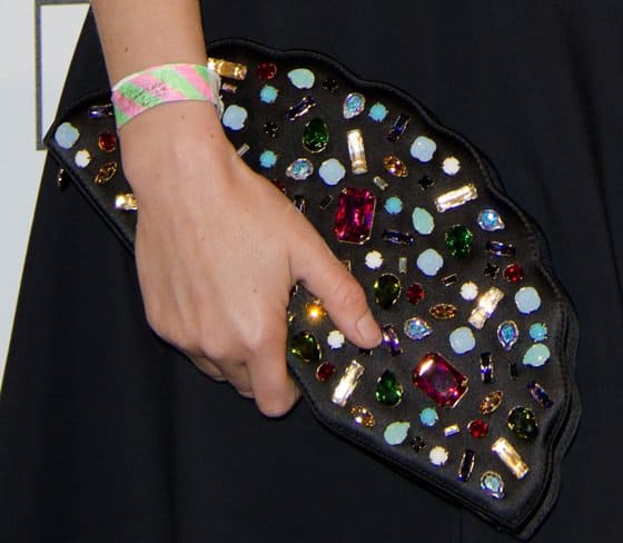 Jasmine Guinness totes Lulu Guinness' "Paloma Fan" clutch