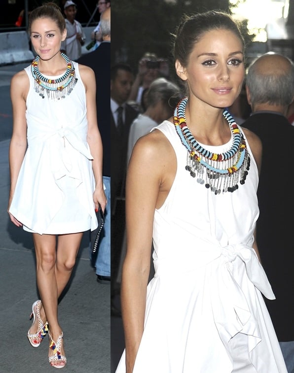 Olivia Palermo wearing a simple white tailored dress with a tie-waist detail