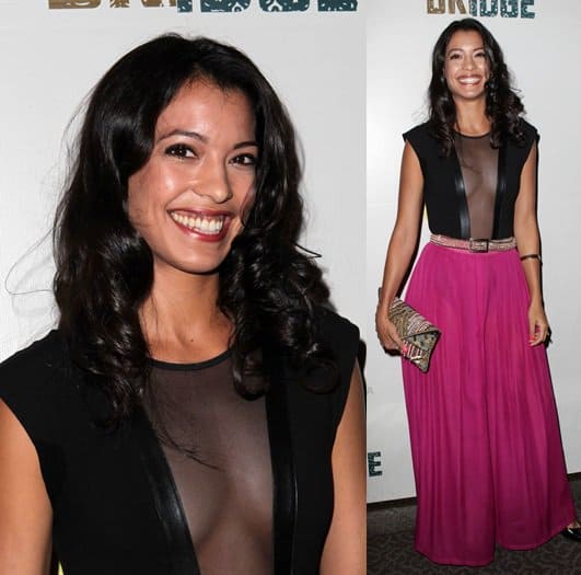 Stephanie Sigman brought bold contrast to the carpet in a sheer-paneled black top and vibrant magenta skirt, accessorized with an ornate beaded clutch and metallic belt for added flair