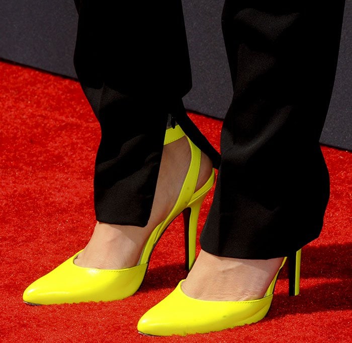 Alyssa Milano displays her feet in neon yellow shoes